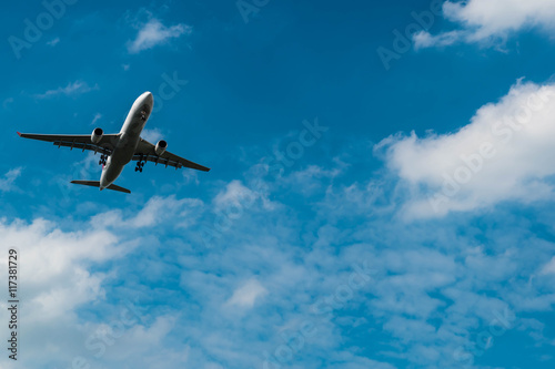 landing airplane in blue sky