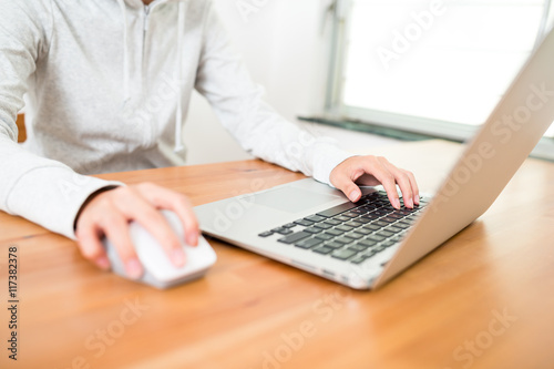 Woman surfing internet by laptop computer