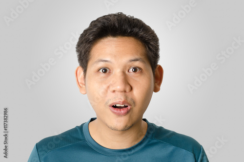Portrait of man feeling wow isolated on gray background