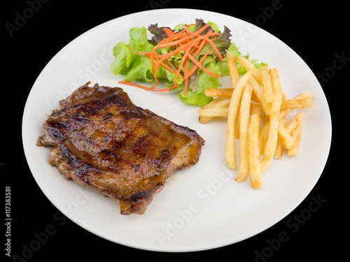 Teriyaki chicken steak served with french fries and salads to vegetables isolated on the black background with clipping path