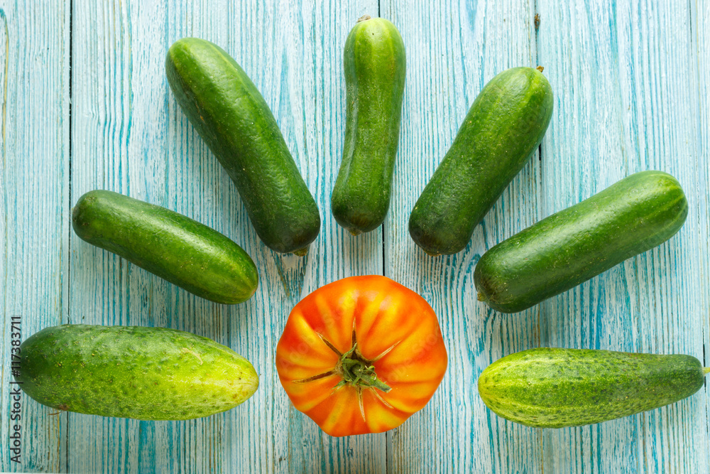 ripe raw tomatoes and some raw ripe cucumbers on wooden backgrou ripe raw tomatoes and some raw ripe cucumbers on wooden backgrou