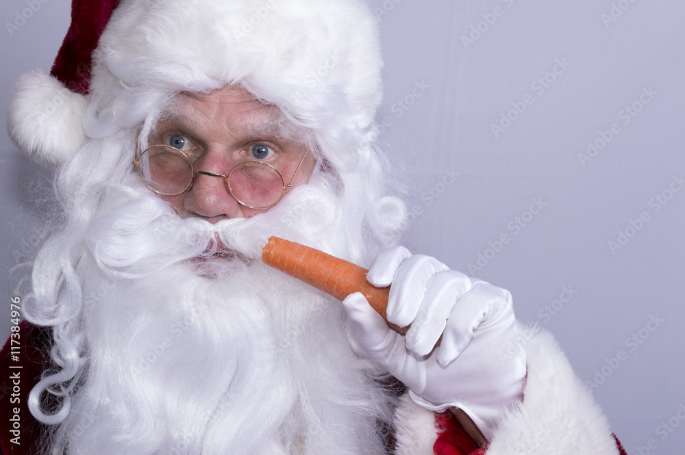 Portrait image of Santa Claus eating a carrot