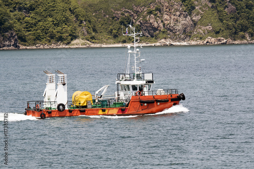 small tug against the shore