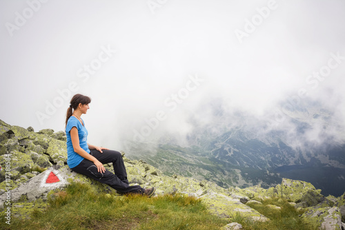 Woman hiker on a top of a mountain