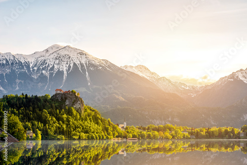 Beautiful morning landscape with castle and snowed up Alpes on the Bled lake in Slovenia.