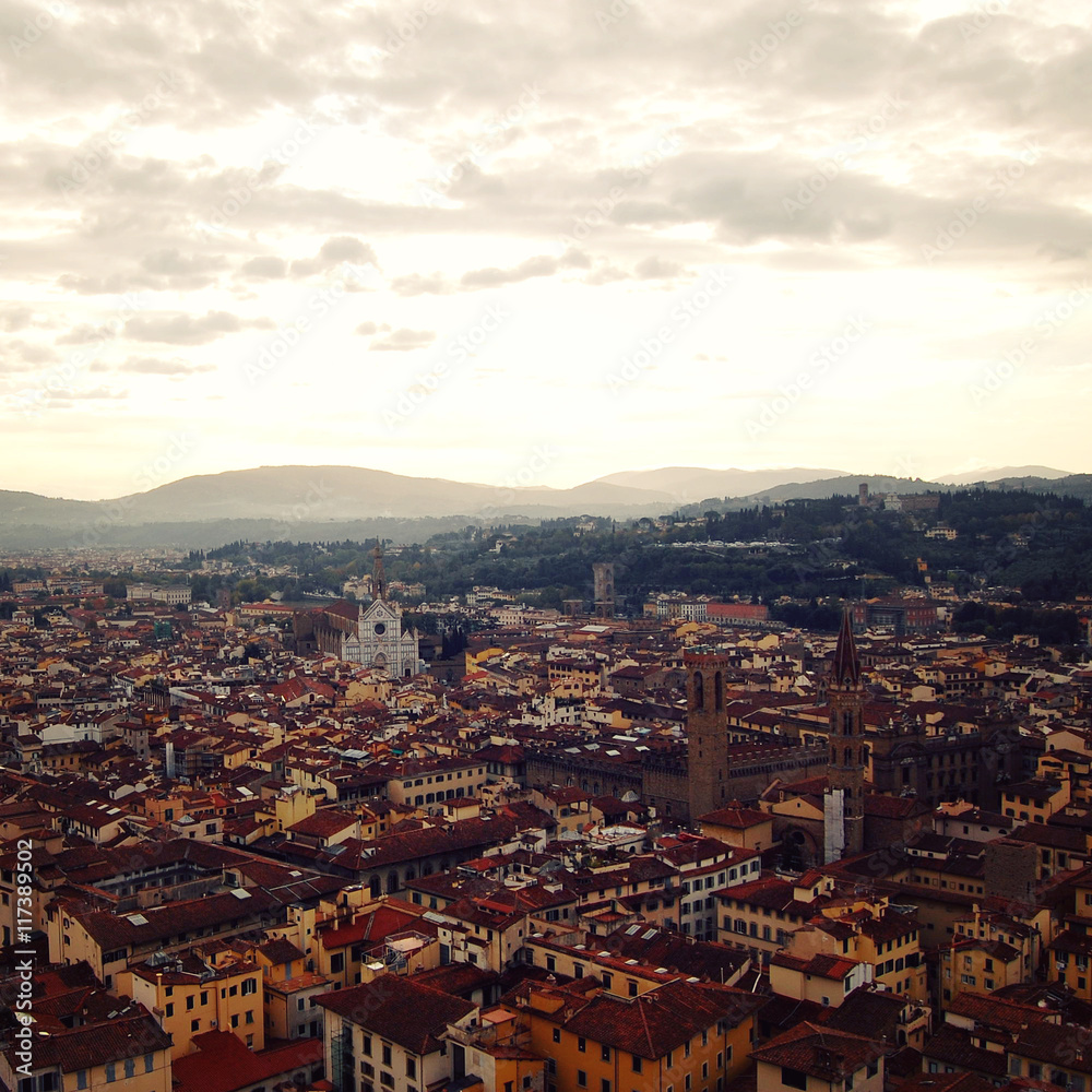 Roofs of Florence from belfry. Aged photo. View of Firenze city with Basilica of Santa Croce in the distance. To the east from Campanile of Florence Cathedral. Sunrise. Italy.