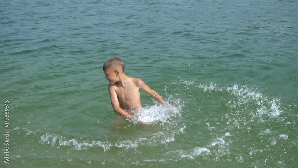 Boy splashing on the beach Boy splashing on the beach