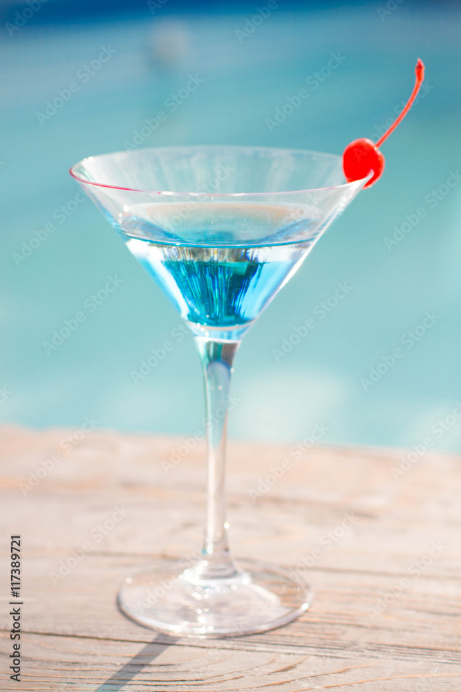 Blue cocktail with a cherry