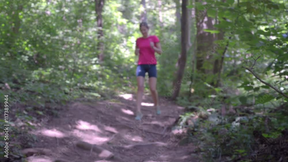 Girl in a red T-shirt and shorts has been running in the woods. Girl in a red T-shirt and shorts has been running in the woods.