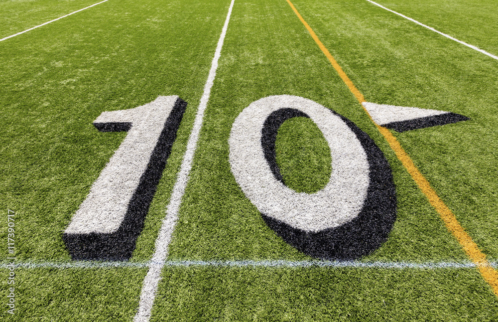 Ten yard line with white lettering on an American football field. Ten yard line with white lettering on an American football field.
