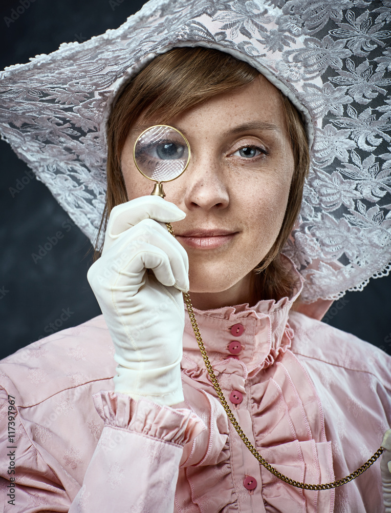 Woman in vintage dress and hat with monocle. Stock Photo | Adobe Stock
