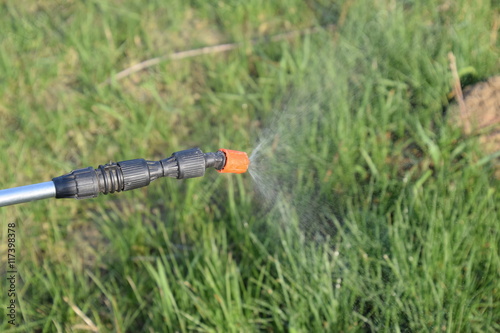 Spraying herbicide from the nozzle of the sprayer manual