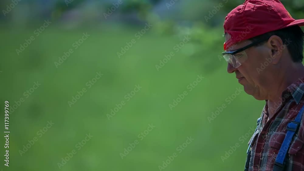 A joiner looks very dedicated and focused when he is cutting wood in the garden. It is a nice summer day. He is wearing his hat backwards.
A joiner looks very dedicated and focused when he is cutting wood in the garden. It is a nice summer day. He is wearing his hat backwards.