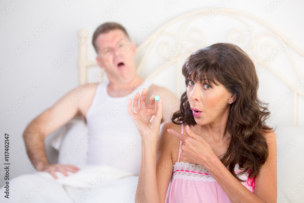 Woman Points to Blue Pill for Erectile Dysfunction as Man Scoffs Woman Points to Blue Pill for Erectile Dysfunction as Man Scoffs