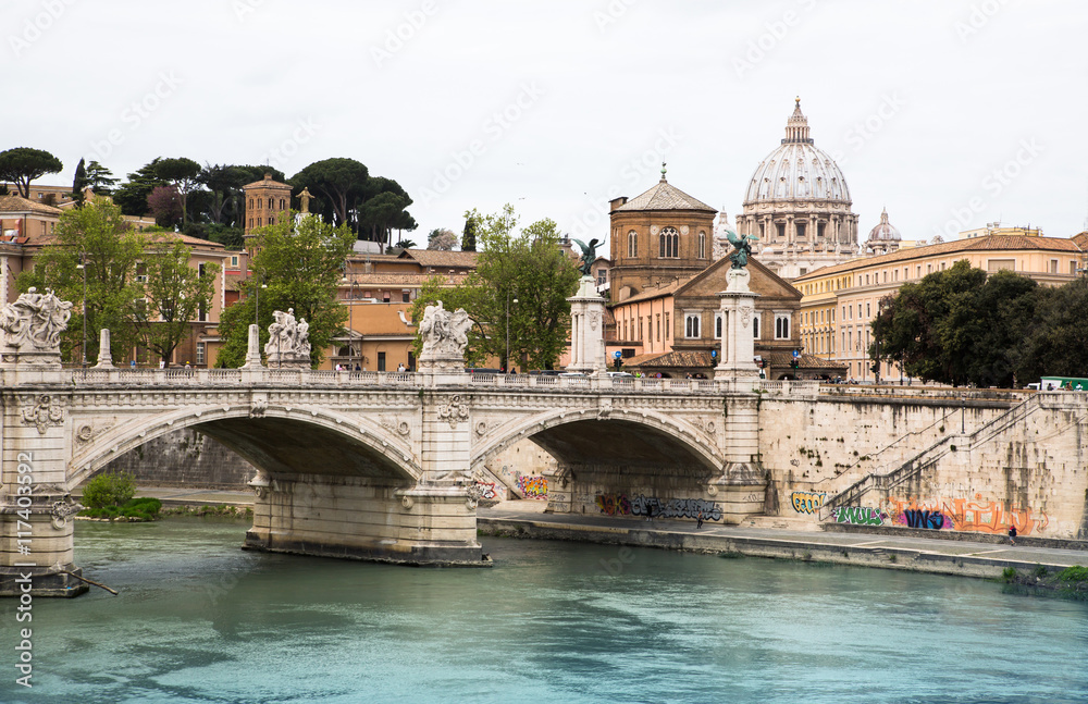 ROME, ITALY - APRIL 8, 2016: St Peter's basilica in Vatican, river Tiber view and Roma'n bridge
