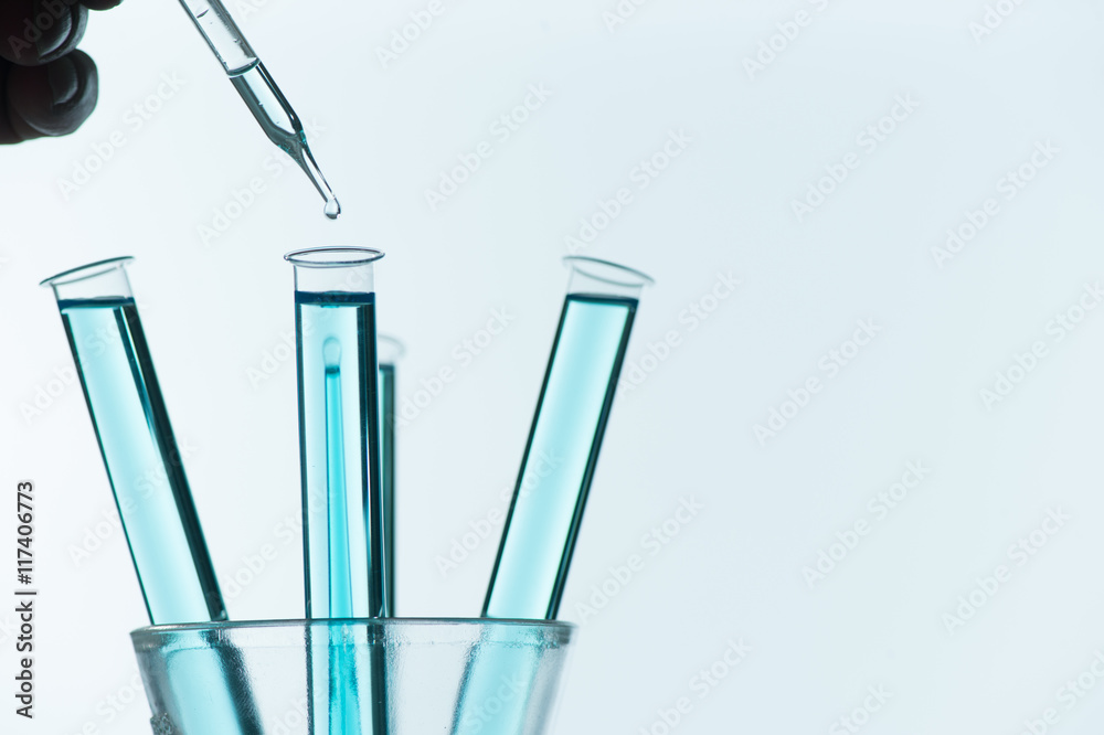 Liquid drop from laboratory glass pipette to test tube Liquid drop from laboratory glass pipette to test tube