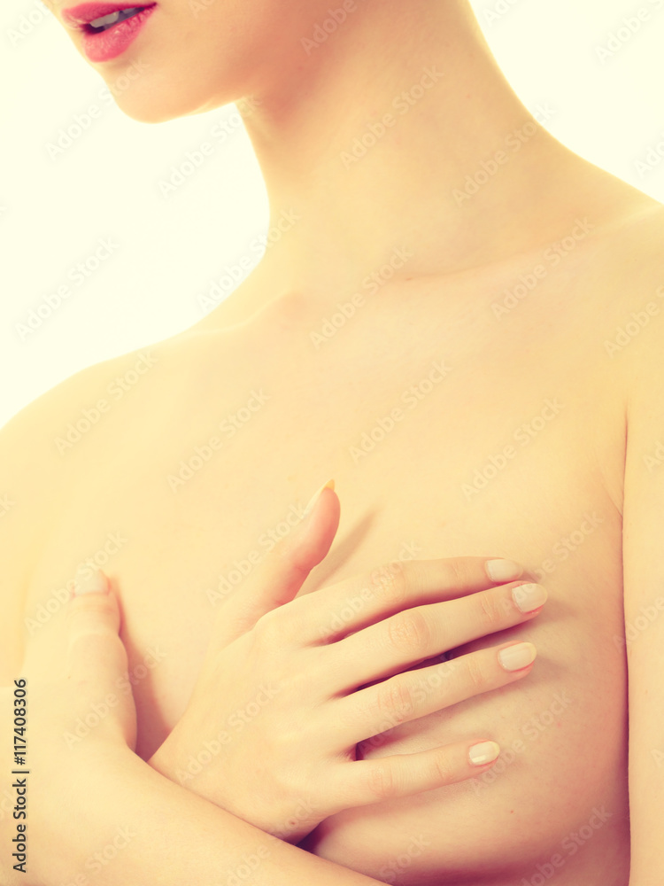 Fototapeta premium Woman covering her breast with hands