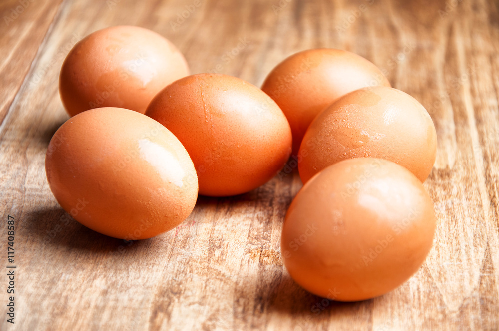The image of eggs on a wooden table. The image of eggs on a wooden table.