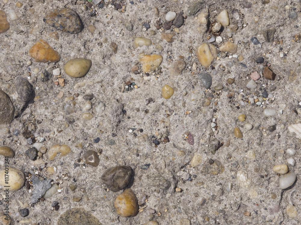 Abstract pebble stones in concrete background texture macro, selective focus Abstract pebble stones in concrete background texture macro, selective focus