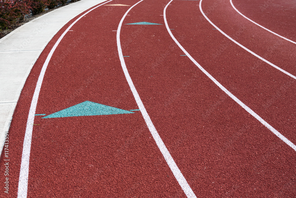 Fototapeta premium Closeup slice of a red school running track 