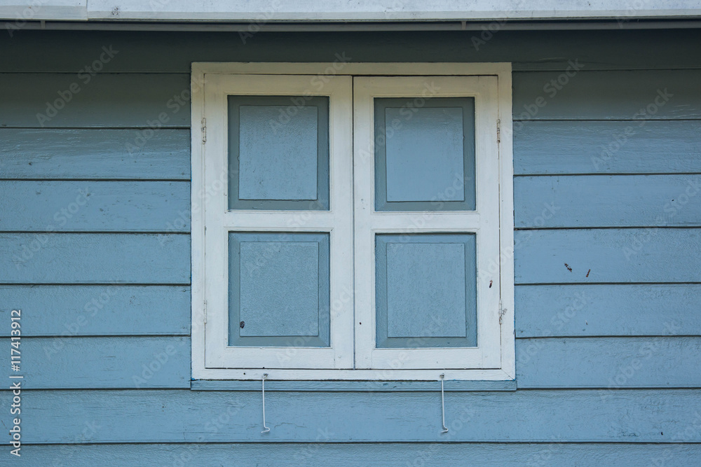 window closed with wooden exterior shutters