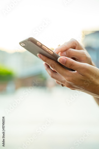 Woman sending sms on mobile phone