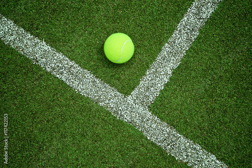 tennis ball near the line on tennis grass court good for backgro © kireewongfoto