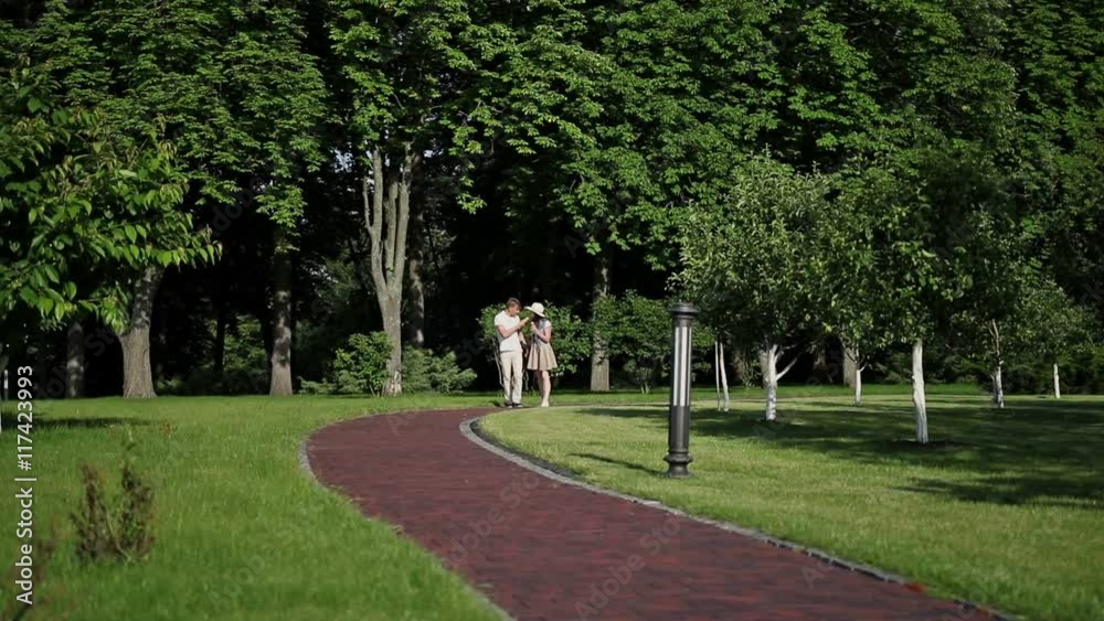 Couple walks in the park and eating ice cream Couple walks in the park and eating ice cream