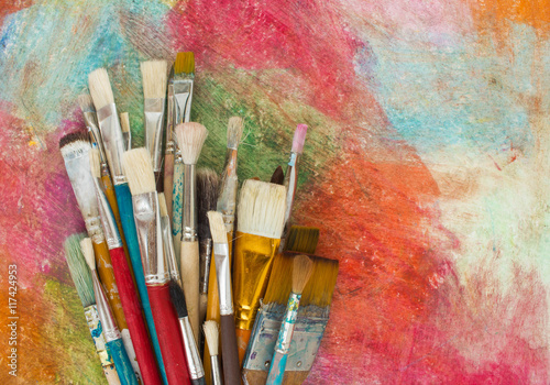 Brushes on a colorful background. The workplace of the artist. Banner for school