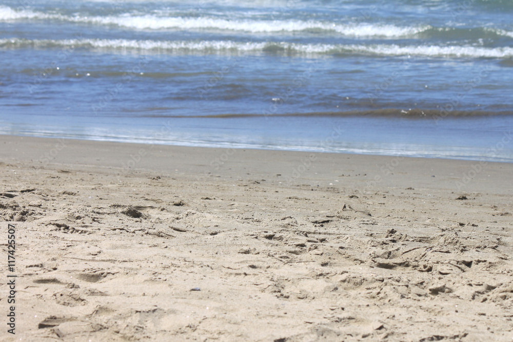 Nature beautiful sand beach background on a summer day. Pure sea water in the summer. Selective focus. Nature beautiful sand beach background on a summer day. Pure sea water in the summer. Selective focus.