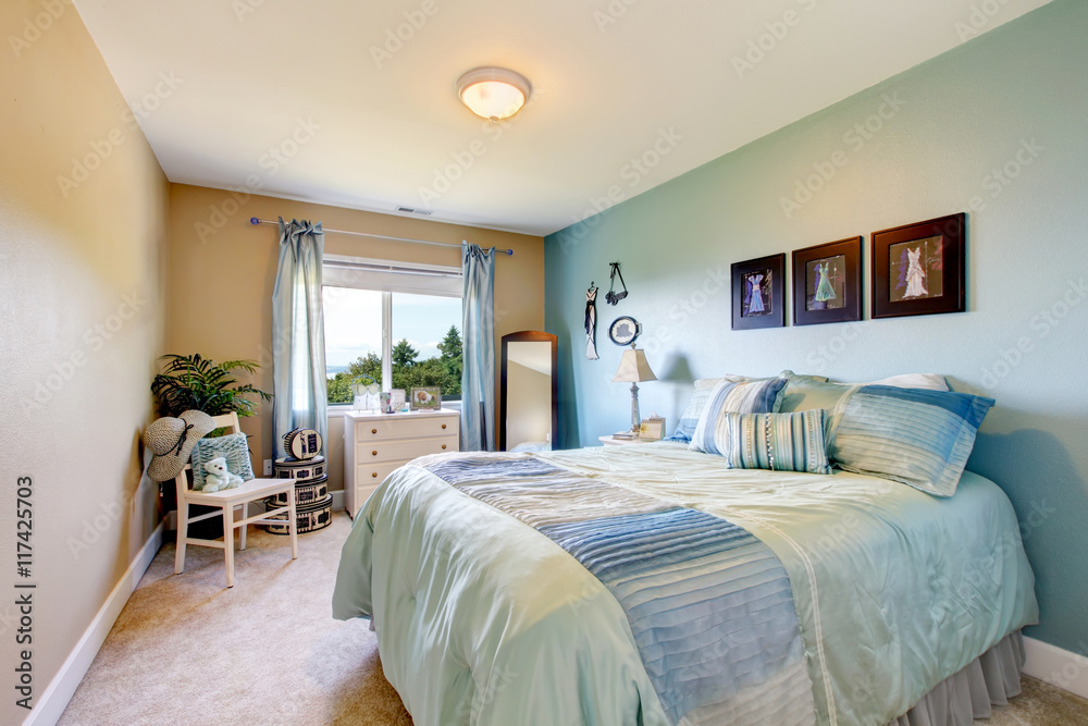 Fototapeta premium Bedroom interior in beige and blue tones. Also blue curtains