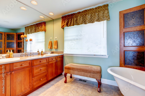 Antique bathroom interior with white bath tub