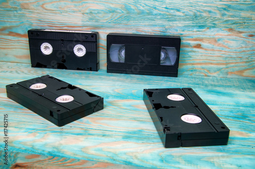 Old VHS tapes cassettes on blue wooden background