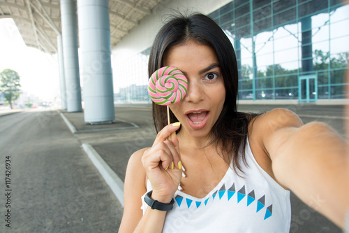 The girl with lollipop photographed herself Selfie style