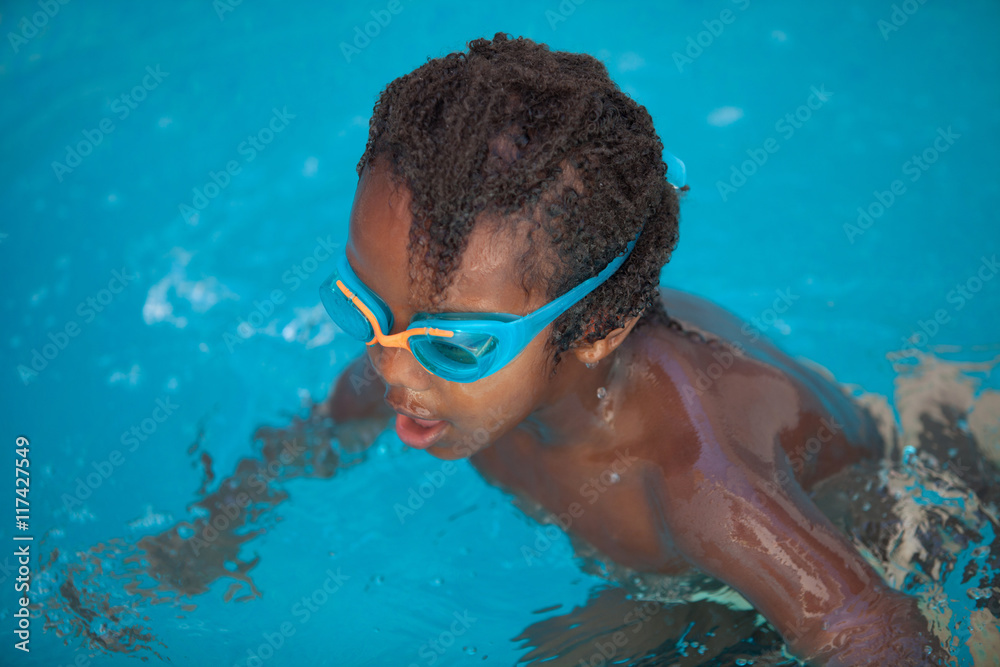 African American child with goggles in the pool