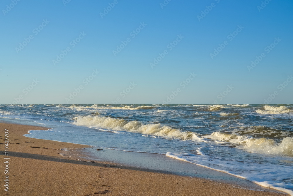 sea, waves, sandy beach and blue sky