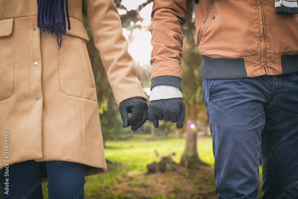 Young couple holding hands in the park.