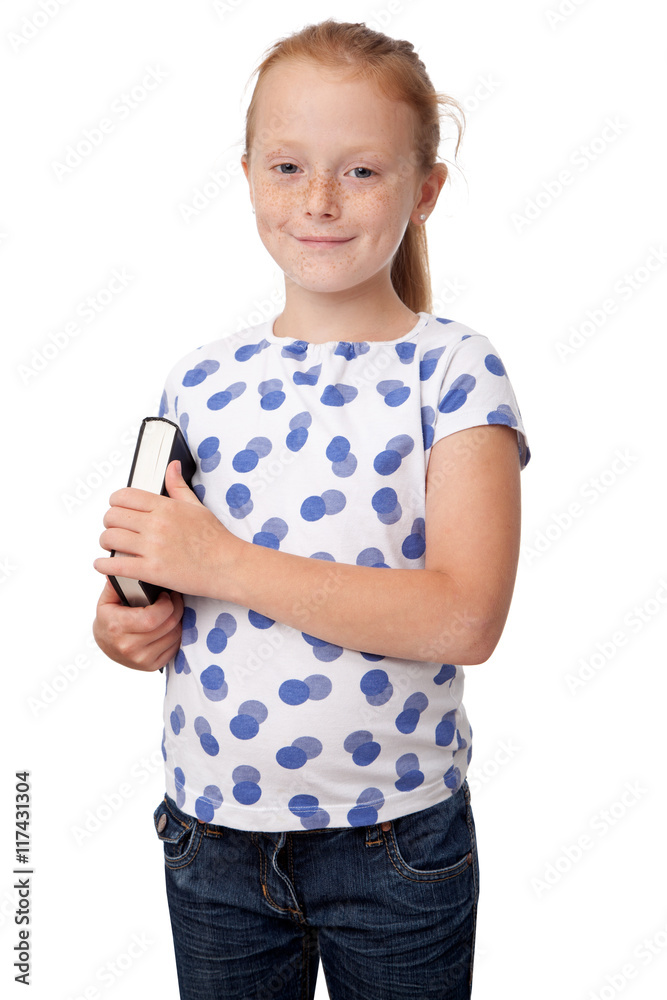 Little girl holding a book, smiling, isolated on white background Little girl holding a book, smiling, isolated on white background