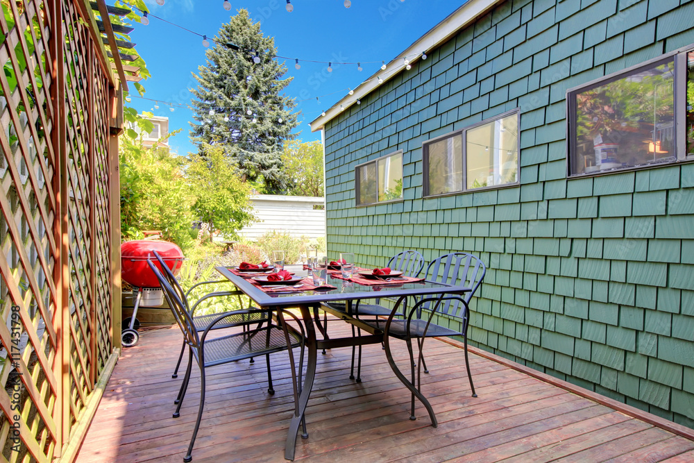 View of Patio table set on small wooden walkout deck