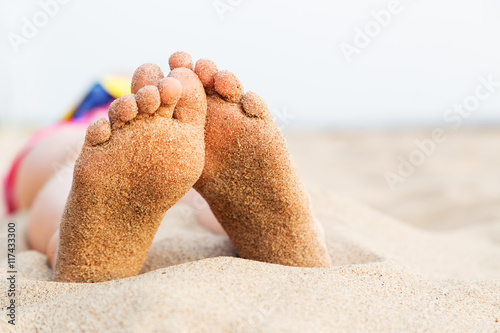 Feet girl relaxing on the beach after swimming