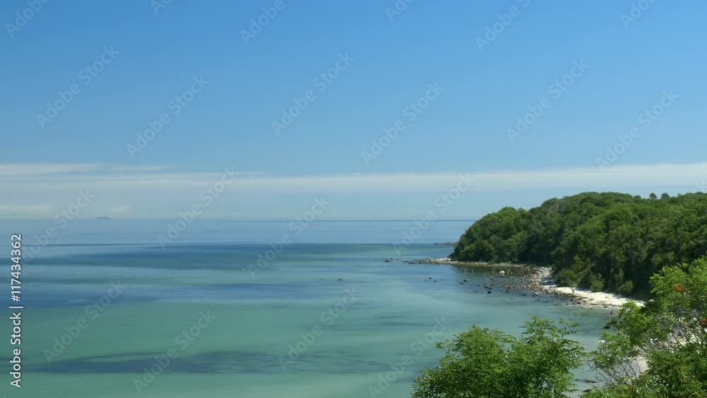 Beach view from cliff. Bay with blue sky. Rügen - Baltic Sea. Clip contains beach, baltic sea, ruegen, sandy beach, beautiful, blue, water, sea, sunny. Beach view from cliff. Bay with blue sky. Rügen - Baltic Sea. Clip contains beach, baltic sea, ruegen, sandy beach, beautiful, blue, water, sea, sunny.