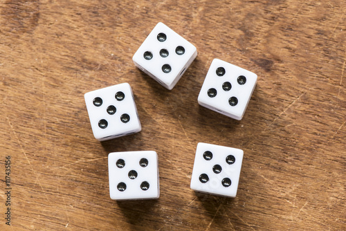 Number five dice on wooden table