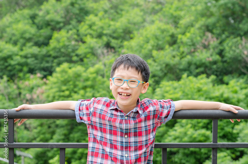 Young asian boy smiling in park