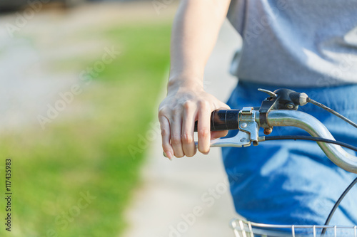 Hand of women clutching the brakes of bicycle.