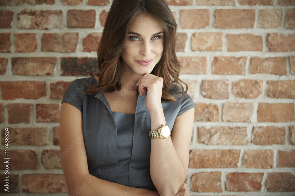 Beautiful business woman standing in front the wall