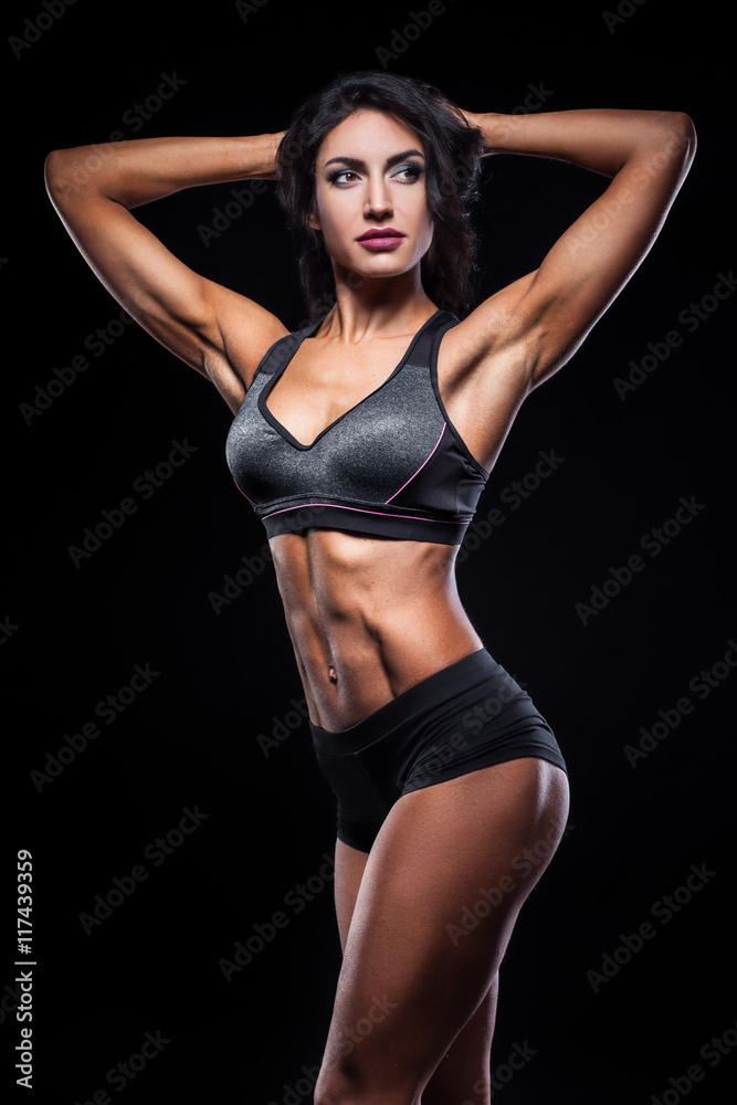 studio shot of perfect body of bodybuilder female;