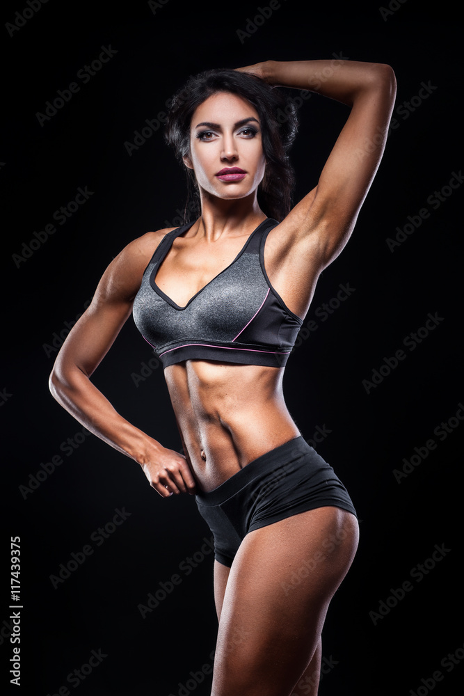 studio shot of perfect body of bodybuilder female;