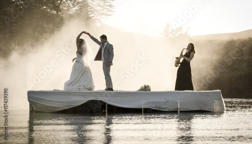 Bride and Groom dancing on a lake to music.