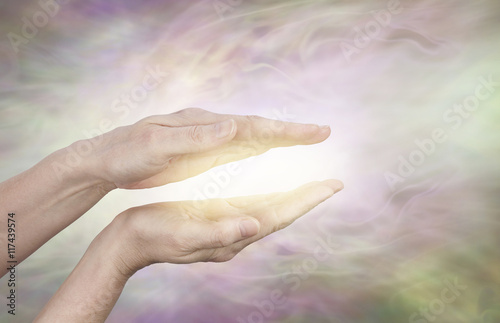 Beautiful Golden Healing Energy - Female healing hands outstretched with  bright shaft of light beaming out and up on a pale golden background Stock  Photo