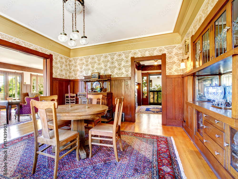 Fototapeta premium Open floor plan antique dining area with wooden pannel trim